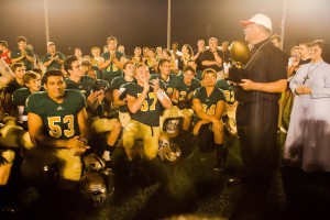 Bishop Richard F. Stika presents the Irish Bowl Trophy to the Knoxville Catholic High School team as diocesan schools superintendent Sister Mary Marta Abbott, RSM, looks on following the Notre Dame-KCHS football game at KCHS Aug. 23 Photos by Stephanie Richer