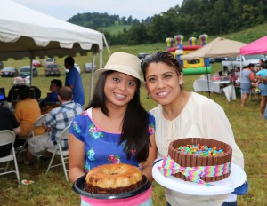 Michelle Morales, left, and her mother, Teresa Morales, show two of the cakes that were sold during an Aug. 30 fundraiser for Blessed Teresa of Calcutta Catholic Mission. Photo by Bill Brewer