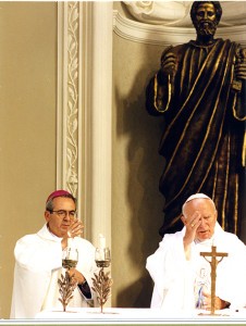 Cardinal Justin Rigali stands with St. John Paul II at the altar. 