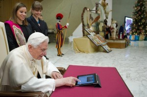 Pope Benedict XVI posts his first tweet on his Twitter account @Pontifex Dec. 12 in Paul VI hall at the Vatican.
Pope Benedict XVI posts his first tweet on his Twitter account @Pontifex Dec. 12 in Paul VI hall at the Vatican.CNS photo/L Osservatore Romano via Reuters[/caption]VATICAN CITY —</strong> Pope Benedict XVI launched his very own Twitter account, sending a short inaugural message to his more than 1 million followers.<br />
“Dear friends, I am pleased to get in touch with you through Twitter. Thank you for your generous response. I bless all of you from my heart,” it said.<br />
His tweet — 139 characters — went viral as the number of followers of @Pontifex and its seven other extensions grew by more than 5,000 new people an hour, a Vatican official said. Tens of thousands of followers retweeted the messages in the short minutes after they were posted.<br />
After the pope gave his catechesis and blessing to those gathered for the general audience in the Vatican’s Paul VI hall, an announcement came over the speakers saying the pope was about to make his first tweet.<br />
<span id=