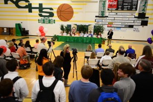 Knoxville Catholic High School student athletes sign scholarship papers Feb. 6 during a National Signing Day ceremony in the school's gym. Photo by Deacon Patrick Murphy-Racey