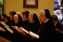 DEVOTIONS TO A CONSECRATED LIFE Sister Mary Clara Auer, FSGM, right, is joined by Sisters Mary Christine Cremin, RSM, Mary Elizabeth Ann McCullough, RSM, Mary Timothea Elliott, RSM, Mary Sarah Macht, RSM, Mariana Koonce, RSM, and Mary Marta Abbott, RSM, during the Solemn Vespers service to recognize World Day for Consecrated Life Feb. 10 at Sacred Heart Cathedral. Photo by Dan McWilliams