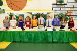 GOING TO THE NEXT LEVEL Signing to play with colleges are (from left) KCHS athletes Emily Holloway, Kristen Halstead, Martha Dinwiddie, Erika Miller, Kathryn Culhane, Mark Mishu, Suddy Hutchins, Aaron Aucker, Ashley Welborn, and Riley McMillan. The signing ceremony was held Feb. 6 at KCHS. Photo by Deacon Patrick Murphy-Racey