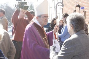 Cardinal Justin Rigali greets parishioners at the Cathedral of the Sacred Heart of Jesus following Sunday Mass as a TV news team films him. Photo by Bill Brewer