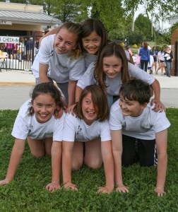 Students from St. Joseph School build a human pyramid before the start of the event at Catholic Charities' "Kids Helping Kids Fun Walk," held April 21 at Knoxville Catholic High School. Bottom row (from left): Kirsten Mahon, Emily Wilson, Seth Lawson; Top row (from left): Claire Earl, Mary Wilson, Rory Mahon. Photo by Stephanie Richer