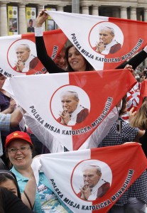 Pilgrims in St. Peter's Square hold up handkerchiefs featuring Blessed John Paul II the day after his beatification in 2011. The late Polish pontiff will be declared a saint, the Vatican said July 5, after officials approved a second miracle attributed to his intercession. Catholic News Service  photo/Paul Haring
