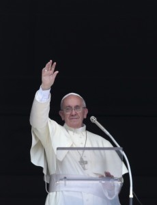 Pope Francis waves as he leads the Angelus in St. Peter's Square at the Vatican Sept. 1. CNS photo/Tony Gentile/Reuters)