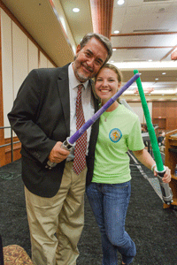 EN GARDE! Dr. Scott Hahn and Diocese of Knoxville youth leader Monica Raymond of St. Albert the Great Church in Knoxville embrace the Star Wars theme as the introduction to Dr. Hahn’s special address to youth attending the Eucharistic Congress. The teens portrayed Dr. Hahn as Dr. Scott Hahn-Solo, who played along, saying “help me Jesus Christ, you’re my only hope.” Photo by Stephanie Richer