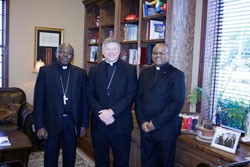 TWO BISHOPS AND FATHER ABUH Bishop Richard F. Stika is flanked by Archbishop Dr. Augustine Obiora Akubeze and Father Julius Abuh during a gathering in Bishop Stika’s office. Photo by Bill Brewer