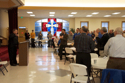 A ROUND OF APPLAUSE Bishop Richard F. Stika receives a warm response from some 165 men attending “A Diocesan Men’s Conference: A Dialogue With Our Shepherd” that was held Jan. 11 at All Saints Church. Bishop Stika was the event’s speaker. Photo by Scott Maentz