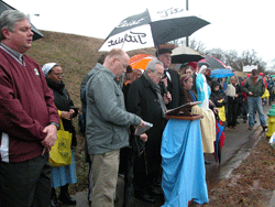 SANCTITY OF LIFE Cardinal Justin Rigali uses a microphone to pray the rosary with some 250 pro-life supporters at the Rosary For Life Jan. 11 near Planned Parenthood’s East Knoxville facility. Deacon Sean Smith (far left) and Paul Simoneau (left center) assisted Cardinal Rigali during the event. Photo by Bill Brewer