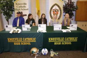 Knoxville Catholic High School athletes, from left, Patrick McFall, Camille Baker, Molly Dwyer, Charlotte Sauter, and Tori Sanders sign college athletics scholarship papers on Feb. 5 at the high school. Photo by Dan McWilliams  