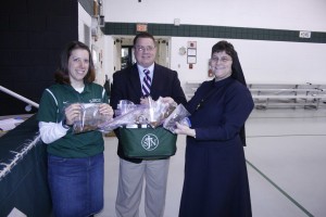 St. John Neumann School teacher Michelle Dougherty, Principal Bill Derbyshire, and diocesan schools superintendent Sister Mary Marta Abbott, RSM, show the hair donated in the school's annual ponytail drive. Photo by Bill Brewer
