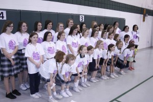 St. John Neumann School students who donated hair in the 2014 Ponytail Drive pose for a group photo in the school gym. Photo by Bill Brewer
