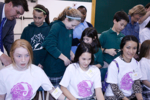 LOVE OFFERING St. John Neumann School students and parents take part in the fourth annual Ponytail Drive to benefit cancer patients. Girls and some mothers volunteer to grow out their hair and then have it cut as a way to give back to a good cause. The American Cancer Society and Pantene help sponsor the event. Photo by Bill Brewer