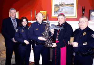 PATRON PROTECTOR Bishop Richard F. Stika presents a St. Michael the Archangel statue to Knoxville Police Department Chief David Rausch, left, Deputy Chief Gary Holliday, far right, Capt. Eve Thomas, second from left, and Lt. Doug Stiles, far left.  Photo by Bill Brewer