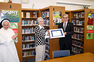 TEACHER OF THE YEAR Marsha Sega receives her honor from Rafael Pubillones on April 17 in the St. Mary School library. Photo by Dan McWilliams