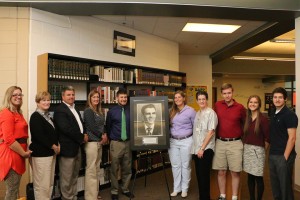 Knoxville Catholic High School faculty and alumni are shown with the new portrait of Cormac McCarthy drawn by KCHS alum Eric Theodore that will be displayed in the school library. From left are Suzi Judd (English Dept.), Dawn Harbin (librarian), Dickie Sompayrac (president), Diannah Miller (Development/Alumni Affairs), Eric Theodore (’11), Alec Cunningham (’11), Jane Walker (academic dean), Kyle Botica (’08), Kelsey Theodore (’10), and Luke Theodore (‘14). Photo by Bill Brewer