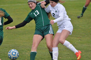 RIVALS FACE OFF for state title Isabelle Pinzon (13) of Knoxville Catholic battles Emma Higgins of Notre Dame for a loose ball in the Class A-AA soccer state championship game, won by Knoxville Catholic 4-0. Courtesy of Gayle Schoenborn