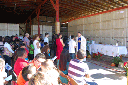 GIVING THANKS Father David Boettner, pastor of the Cathedral of the Sacred Heart of Jesus, celebrates Mass at Scott Farms in Unicoi for more than 250 agricultural contract workers, their families and friends to mark the end of the growing season in East Tennessee. Many of the workers return home to Mexico for the winter once the crops have been harvested.  Photo by Jim Wogan