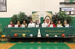 Nine Knoxville Catholic High School student athletes signed with colleges on Feb. 4. From left are Mike Fitzgerald, Delaney Lowery, Allie McLaughlin, Logan Lacey, Jordan Anderson, Zac Jancek, Ashley Hickman, Morgan Briggs, and Elise Klug. Photo by Dan McWilliams