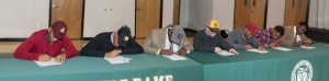 Notre Dame High School had a record seven student athletes sign college scholarships to play football on National Signing Day, Feb. 4. Pictured seated are Kareem Orr (Arizona State), AJ Flemister (Tennessee Tech), Joe Dossett (ETSU), Austin Banks (Kennesaw State), Josh Russell (Cumberland University), Kealey Green (Cumberland University), and William Montgomery (Jacksonville University). Photo by Gayle Schoenborn