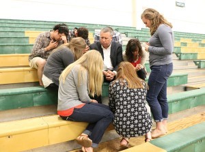 FOCUS founder Curtis Martin, center, prays with FOCUS missionaries who attended his talk April 18 at Knoxville Catholic High School. Photo by Bill Brewer 