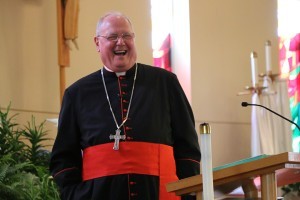 Cardinal Timothy Dolan shares a lighthearted moment with parishioners attending his Following Jesus Conference talk April 18 at All Saints Church. Photo by Dan McWilliams