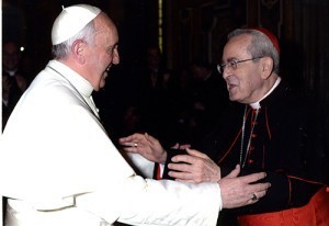 Pope Francis reaches out to Cardinal Justin Rigali during a recent meeting.