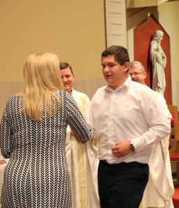 Sean Halstead accepts the SSgt. Leroy A. Petry Challenge Coin from Sacred Heart Principal Sarah Trent on May 22 at the cathedral. Photo by Dan McWilliams