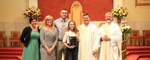 Harrison Smith stands with his scholarship recipient for 2015, Callie Grace Tucker. Also pictured are (from left) Sacred Heart Cathedral director of school admissions and development Joni Punch, Principal Sarah Trent, cathedral rector Father David Boettner, and associate pastor Father Joe Reed. Photo by Dan McWilliams