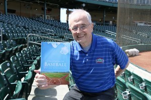 Our Lady of Fatima parishioner Bryan Steverson shows his new book, Baseball, A Special Gift from God, which connects America's pastime to Christianity and the Catholic faith. Photo by Jim Wogan