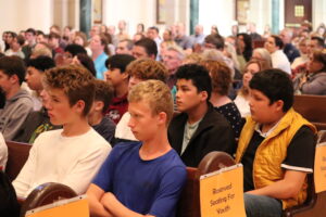 Teen boys sitting in church pews