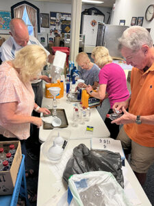 People around a table sort various items
