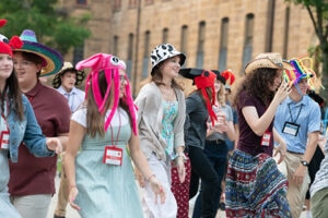 Young people dancing wearing silly hats